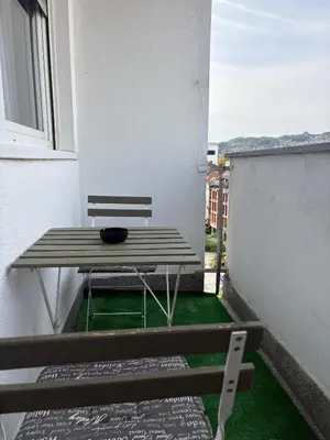 a balcony with a bench and a table and a window at A&N Apartments in Banja Luka