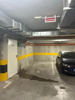 a parking garage with a car parked in it at A&N Apartments in Banja Luka