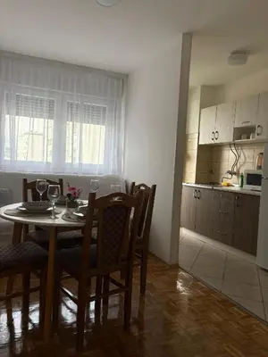 a kitchen and dining room with a table and chairs at A&N Apartments in Banja Luka