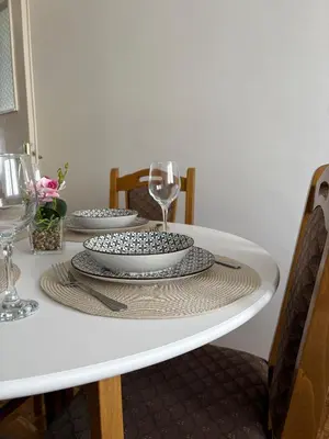 a white table with two plates and a glass at A&N Apartments in Banja Luka