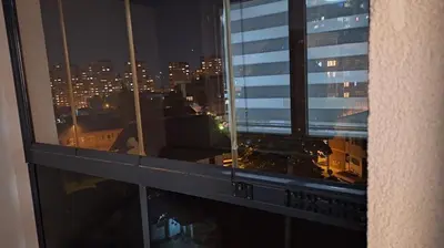 a view of a city at night from a window at Apartman Sunce in Zenica
