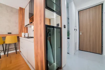 a kitchen with a glass refrigerator in a room at Liberty Studio Tuzla in Tuzla