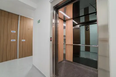 a hallway with a glass door in a building at Liberty Studio Tuzla in Tuzla