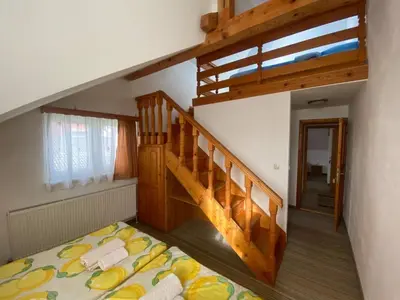 a bedroom with a bunk bed and a staircase at Pansion Tomas Kupres in Kupres