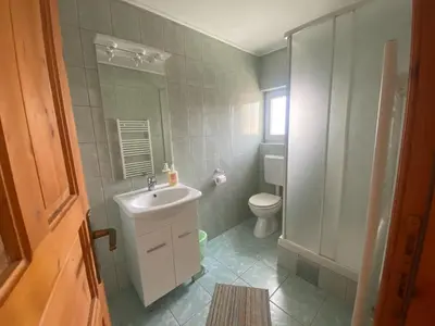 a bathroom with a sink and a toilet at Pansion Tomas Kupres in Kupres