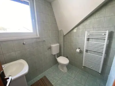 a bathroom with a toilet and a sink at Pansion Tomas Kupres in Kupres