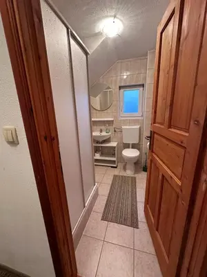 a bathroom with a toilet and a sink at Pansion Tomas Kupres in Kupres