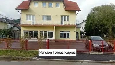 a house with a sign in front of it at Pansion Tomas Kupres in Kupres