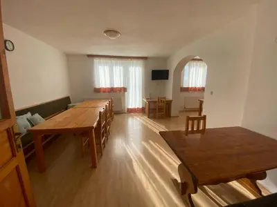 a large room with wooden tables and chairs at Pansion Tomas Kupres in Kupres