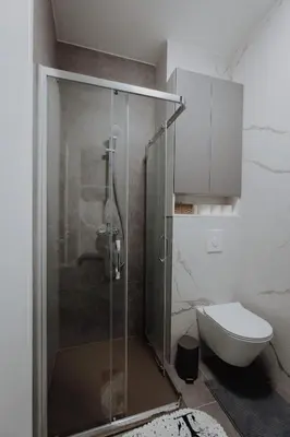 a shower stall in a bathroom with a toilet at BLuxe Residence in Banja Luka