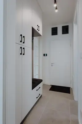 a white room with white cabinets and a door at BLuxe Residence in Banja Luka