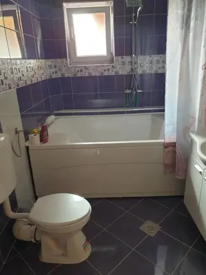 a bathroom with a white tub and a toilet at Villa Big Mama in Živinice