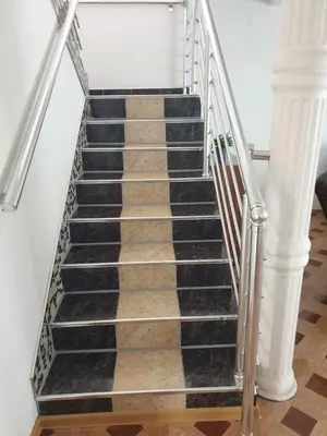 a set of stairs with black and white tiles at Villa Big Mama in Živinice