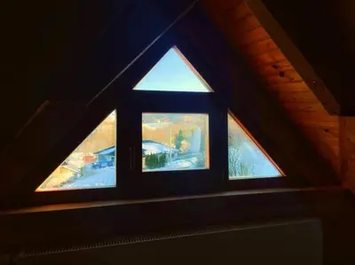 a window in a room with a roof at Vikendica sa bazenom Cazin Pecigrad in Cazin