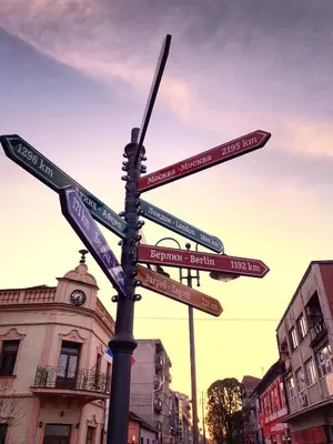 a street sign with street signs on a pole at Apartman Čeliković in Bosanski Šamac