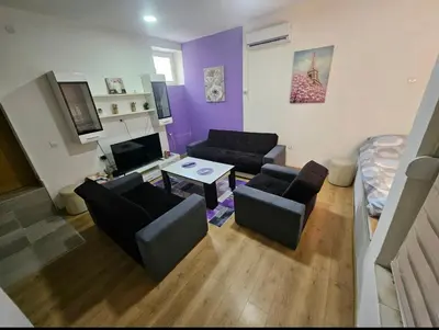 a living room with a couch and a table at Lira Apartmani in Prnjavor