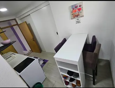 a living room with a white table and chairs at Lira Apartmani in Prnjavor