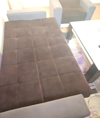 a brown couch sitting in a living room at Lira Apartmani in Prnjavor