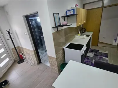 a small kitchen with a stove and a counter top at Lira Apartmani in Prnjavor