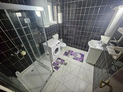 a bathroom with a shower and a toilet and a sink at Lira Apartmani in Prnjavor