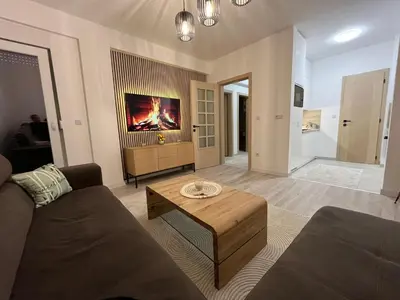 a living room with a couch and a coffee table at Stan na dan TowerLife Gradačac in Gradačac