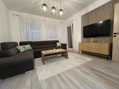 a living room with a couch and a tv at Stan na dan TowerLife Gradačac in Gradačac