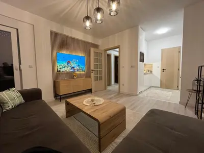 a living room with a couch and a table at Stan na dan TowerLife Gradačac in Gradačac