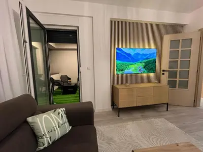 a living room with a couch and a flat screen tv at Stan na dan TowerLife Gradačac in Gradačac