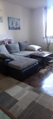 a living room with a couch and a coffee table at Apartman Jelena Lux in Doboj