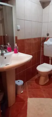 a bathroom with a sink and a toilet at Apartman Jelena Lux in Doboj