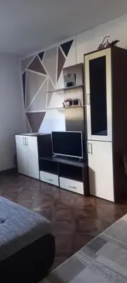 a living room with a tv and a wall at Apartman Jelena Lux in Doboj