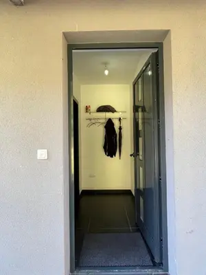 a hallway with an open door with an umbrella at Villa Bukvic in Zavidovići