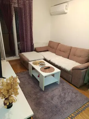 a living room with a couch and a coffee table at Apartman Čakarević in Doboj