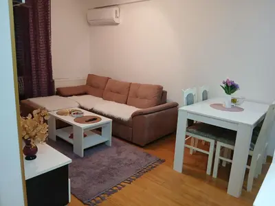 a living room with a couch and two tables at Apartman Čakarević in Doboj