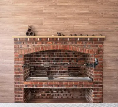 a brick fireplace with a shelf on top of it at Dream House Banja Luka in Banja Luka