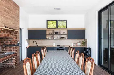a dining room with a long table and chairs at Dream House Banja Luka in Banja Luka