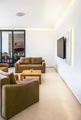 a living room with two couches and a tv at Dream House Banja Luka in Banja Luka