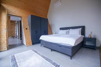 a bedroom with a large bed in a room at Golf Forest Creek Villas in Zavidovići