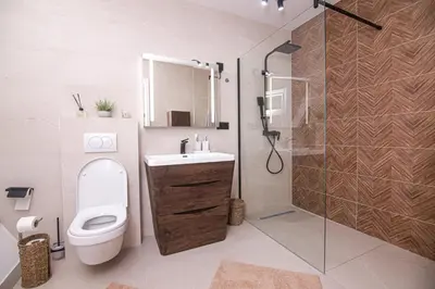 a bathroom with a toilet and a sink and a shower at Golf Forest Creek Villas in Zavidovići