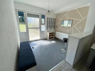 an empty room with a staircase and a room with a desk at Villa Lilak in Bihać