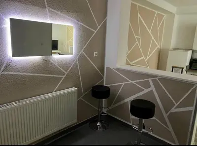 a room with two stools and a mirror on a wall at Villa Lilak in Bihać