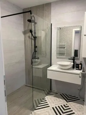 a bathroom with a glass shower and a sink at 3D Caffe Apartmani in Visoko