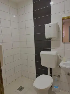 a bathroom with a white toilet and a sink at 3D Caffe Apartmani in Visoko