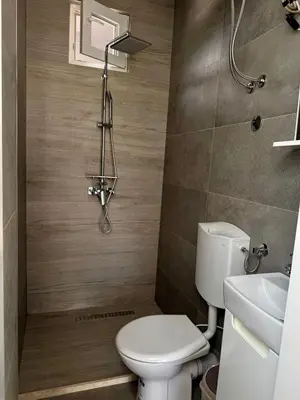 a bathroom with a toilet and a sink at 3D Caffe Apartmani in Visoko