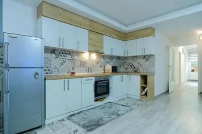 a kitchen with white cabinets and a refrigerator at 3D Caffe Apartmani in Visoko