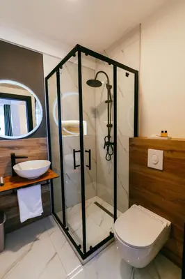 a bathroom with a shower and a toilet and a sink at PARK INN, Bugojno in Bugojno
