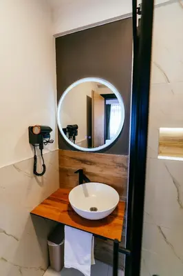 a bathroom with a sink and a mirror at PARK INN, Bugojno in Bugojno