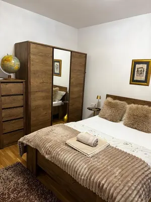a bedroom with a large bed and a mirror at Urban Suite BL Apartment in Banja Luka