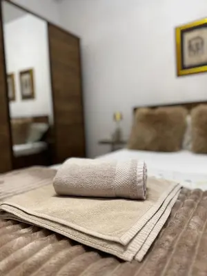 a towel sitting on top of a bed at Urban Suite BL Apartment in Banja Luka