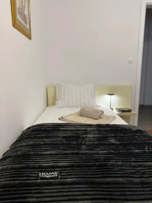 a bed with a hat sitting on top of it at Urban Suite BL Apartment in Banja Luka